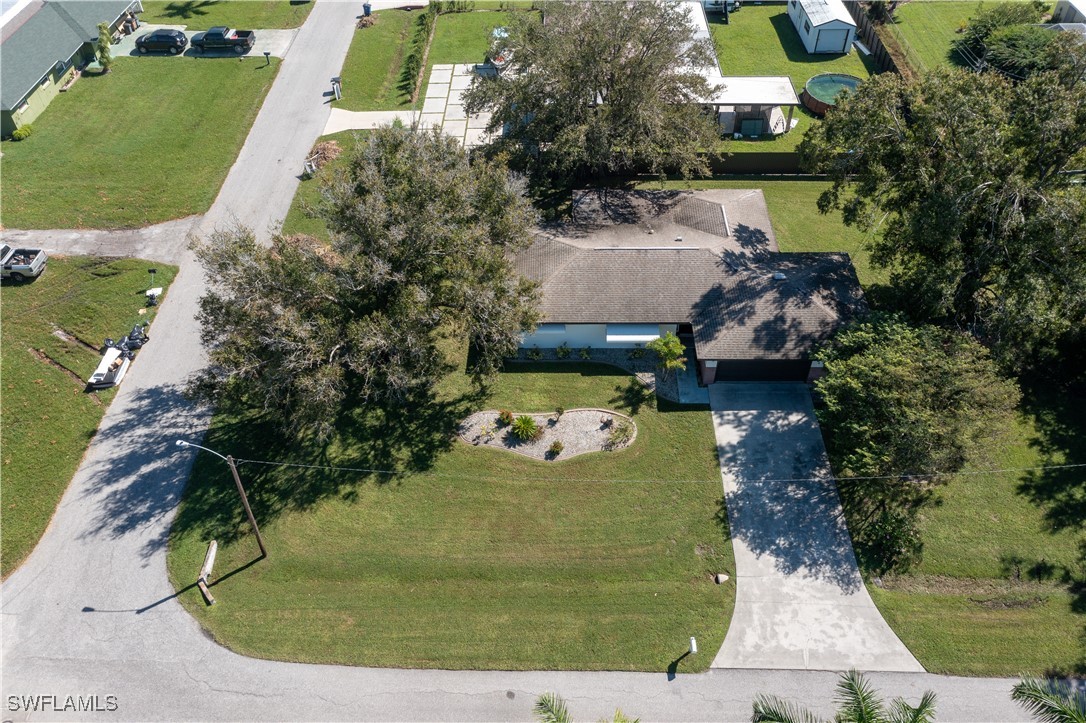 an aerial view of a house with a yard and trees