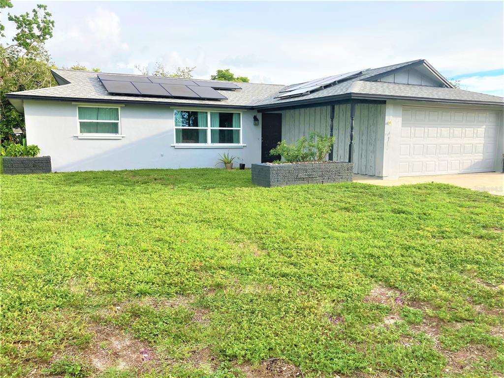 a front view of house with yard and green space