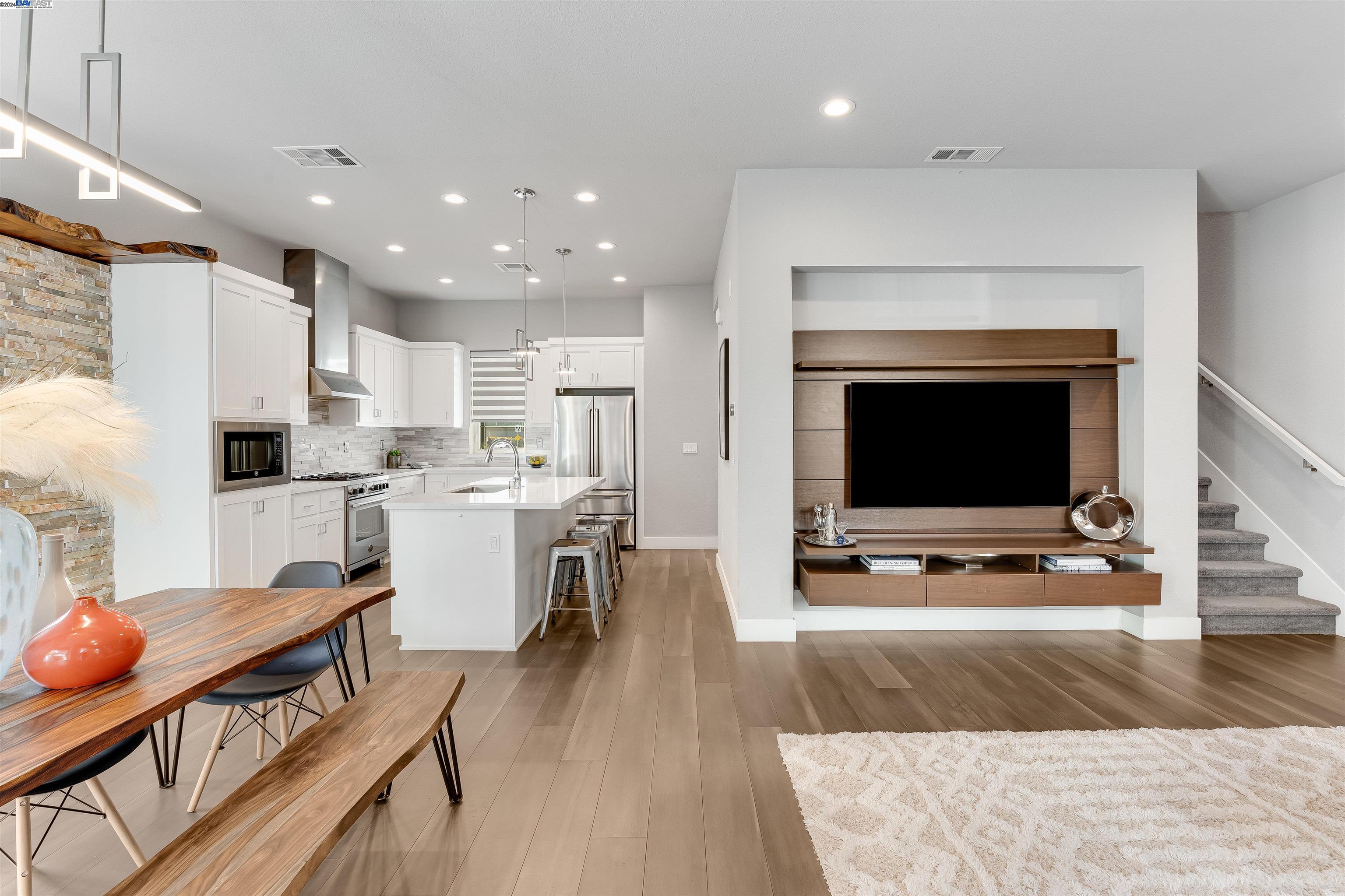 a open kitchen with white cabinets and stainless steel appliances