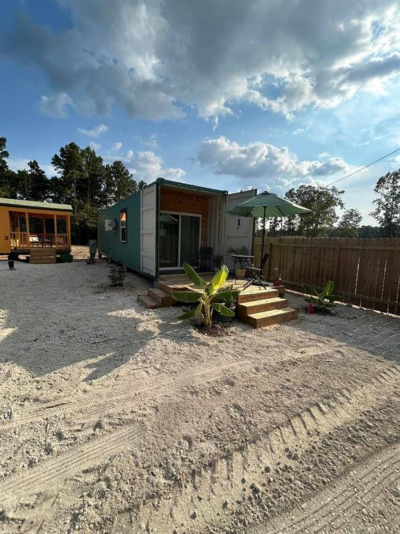 a view of a backyard with furniture and a fire pit