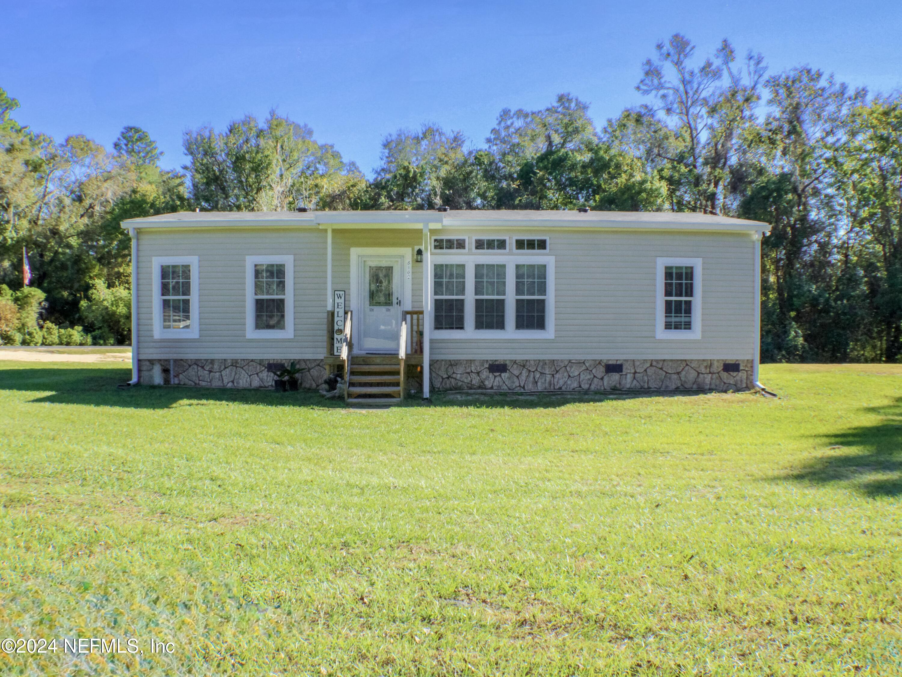 front view of a house with a yard