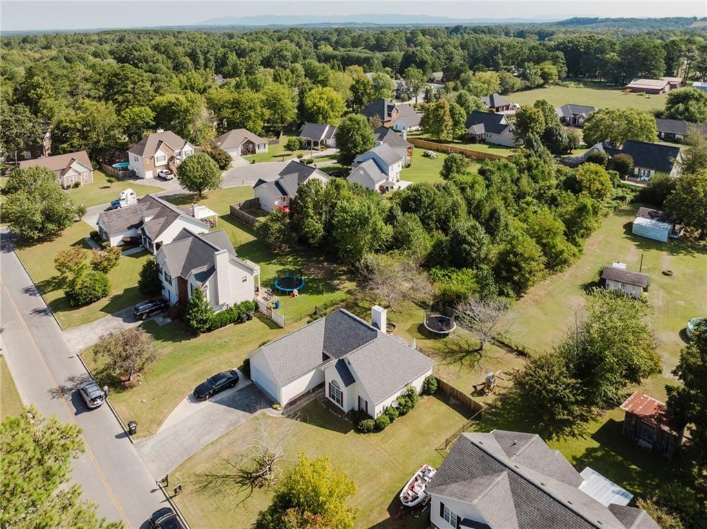 an aerial view of residential houses with outdoor space