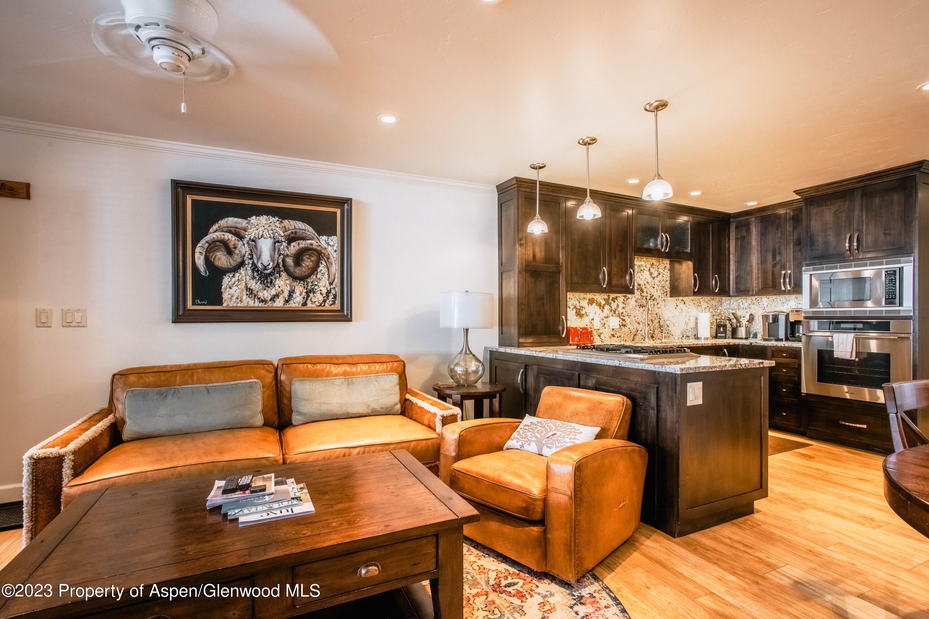 a living room with furniture and kitchen view