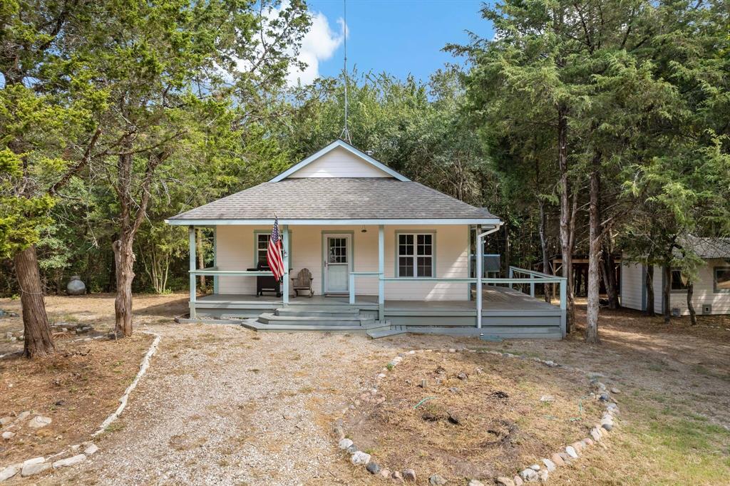 a house with lots of trees in the background