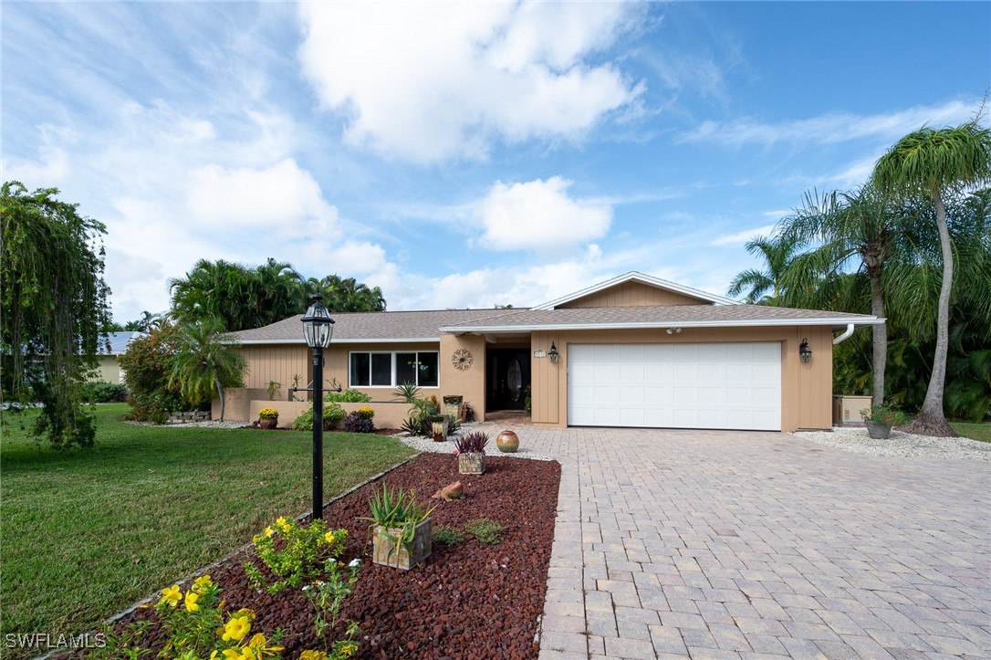 a front view of house with yard and green space