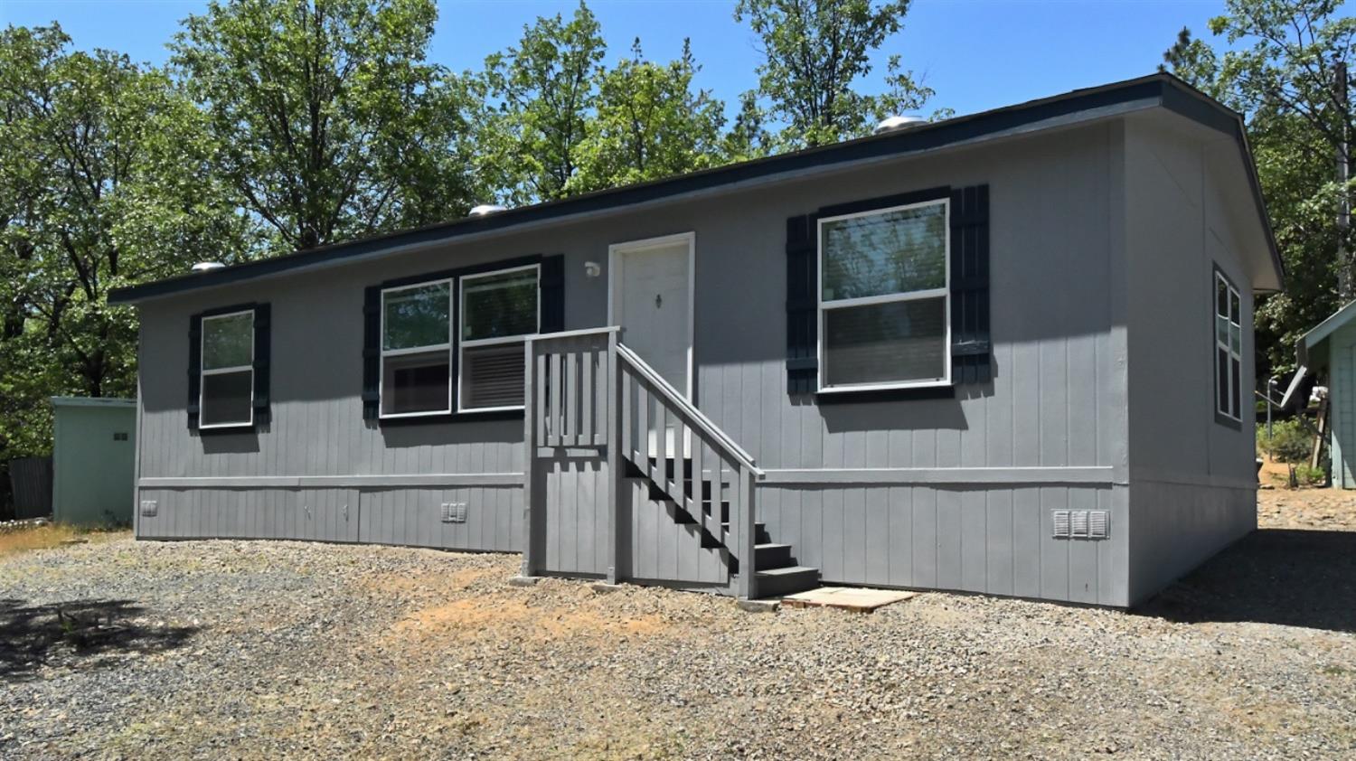 a view of house with small yard in front of it