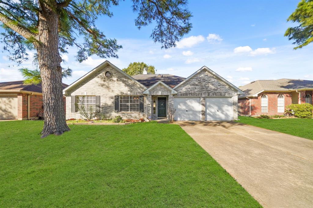 a front view of a house with yard and green space