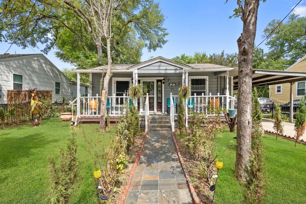 a front view of a house with a garden