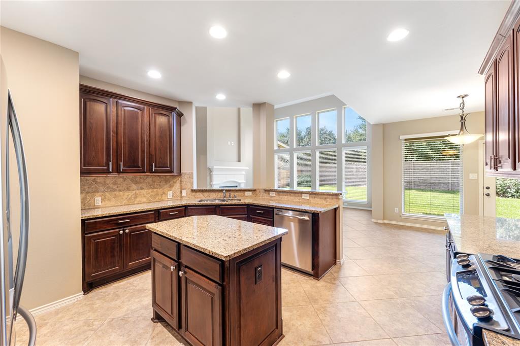 a kitchen with a stove sink and cabinets