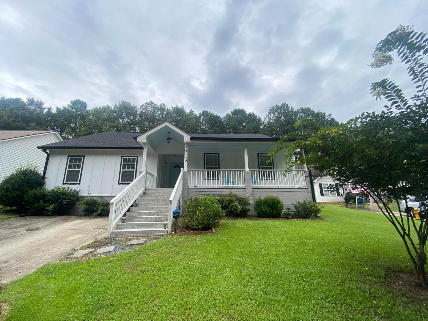 a front view of house with yard and green space