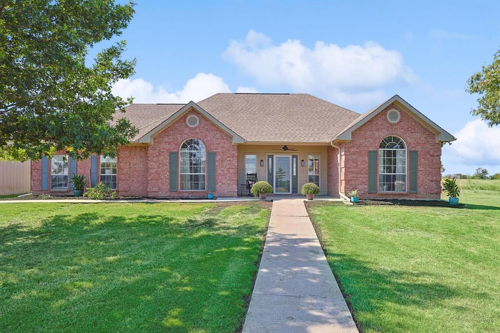 a front view of a house with yard