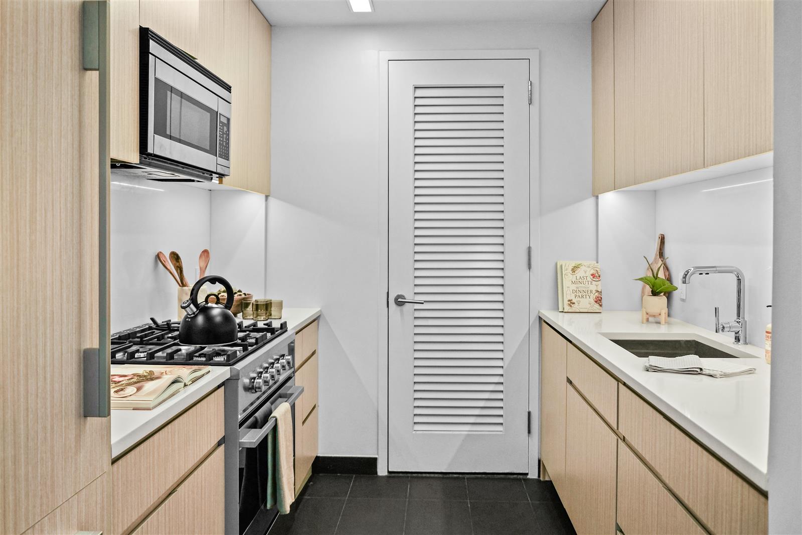 a kitchen with stainless steel appliances granite countertop a sink and a stove