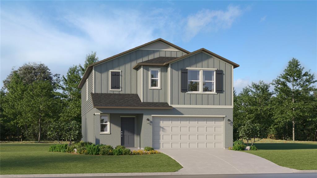 a front view of a house with a yard and garage