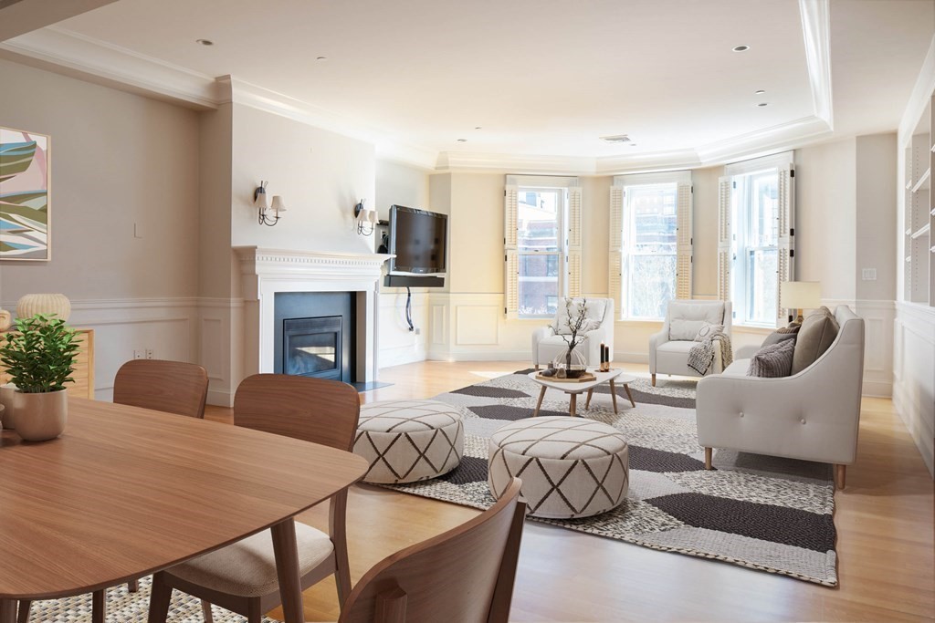 a living room with furniture fireplace and a window