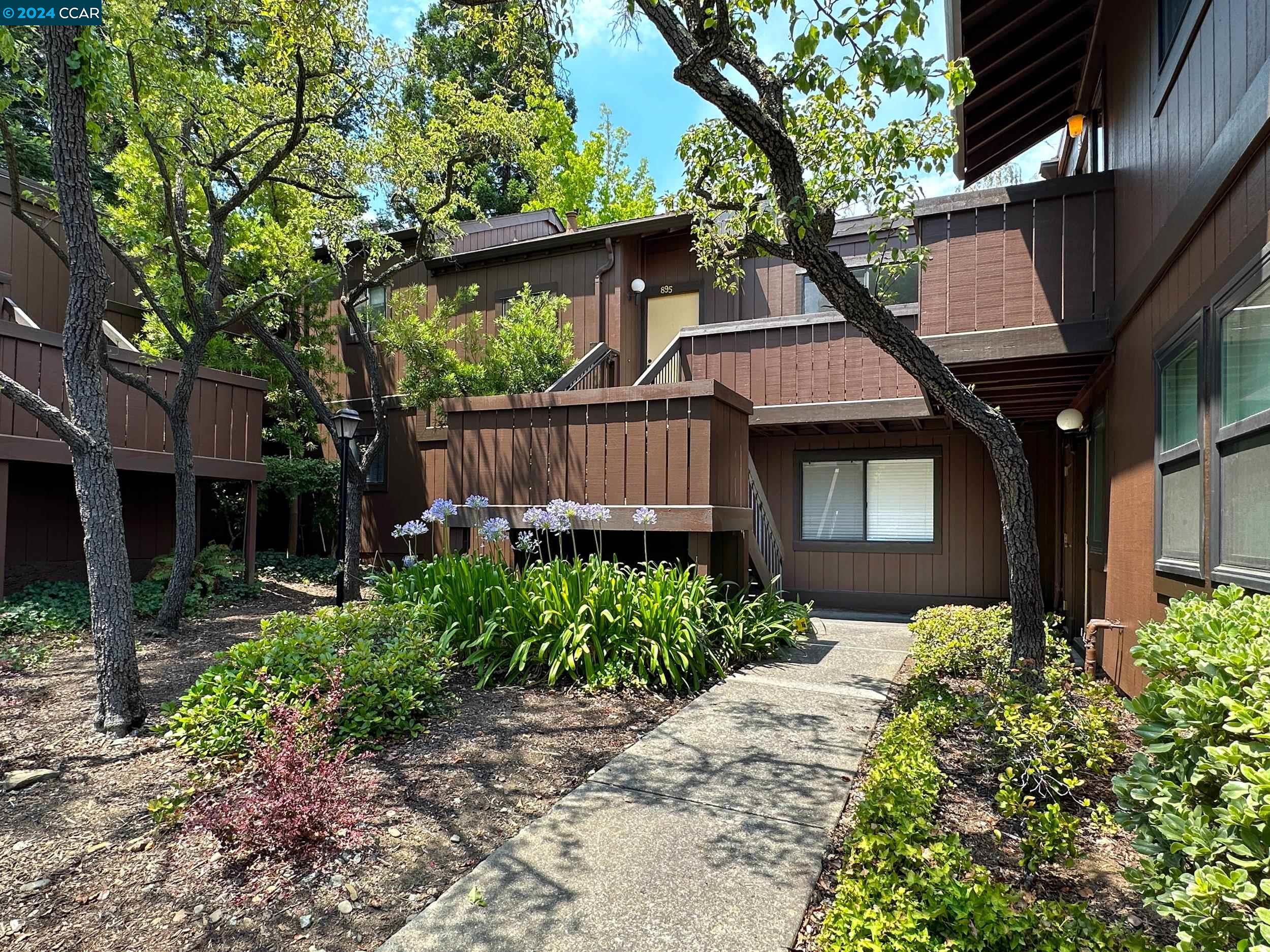 a front view of a house with garden