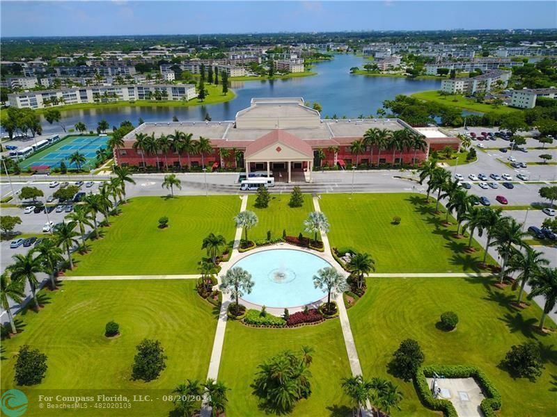 an aerial view of a pool yard ocean and outdoor seating