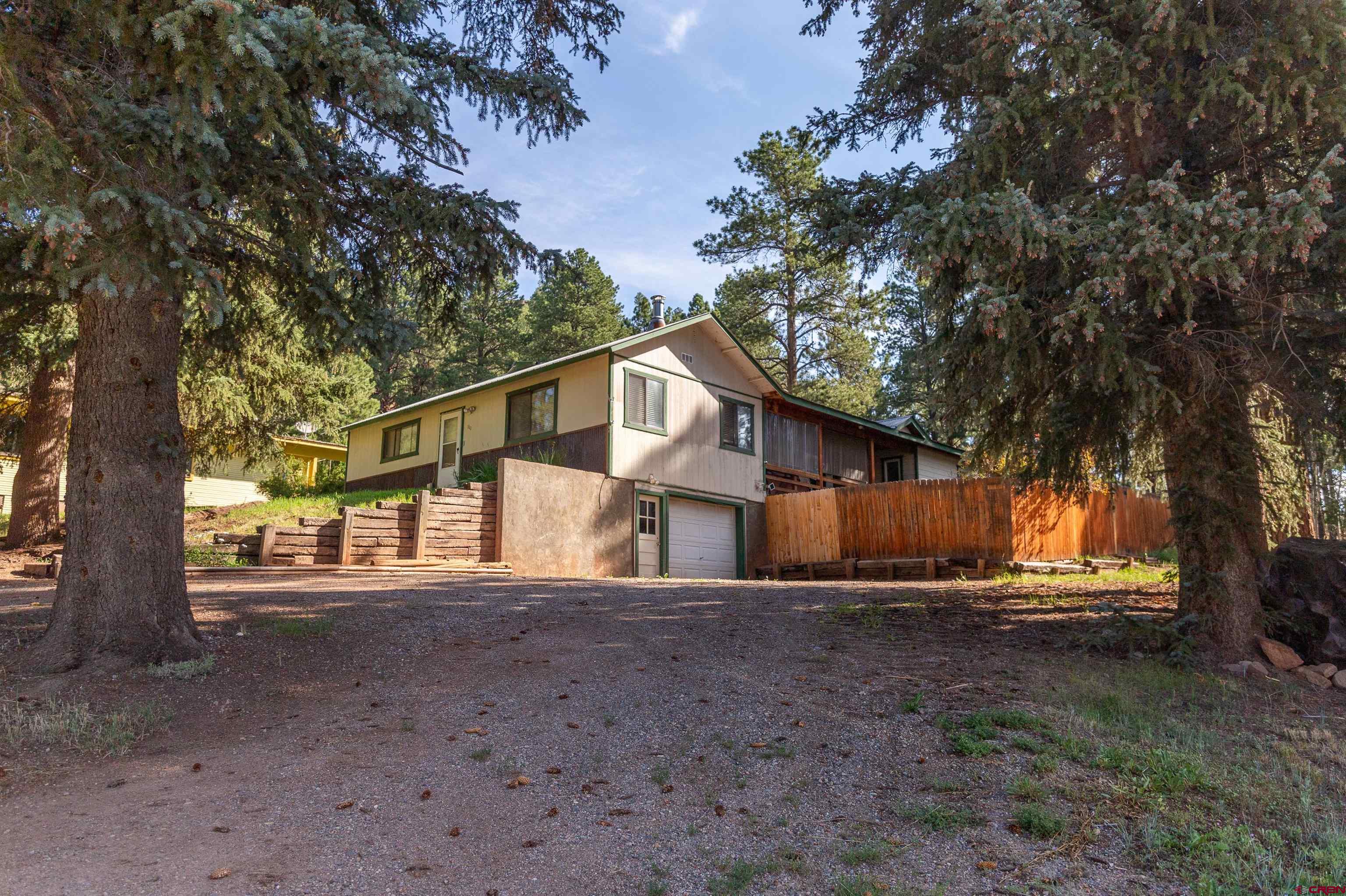 a view of a house with a tree in the yard