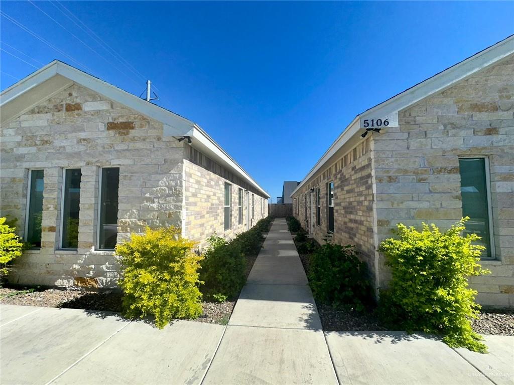 a view of a pathway with a house in the background