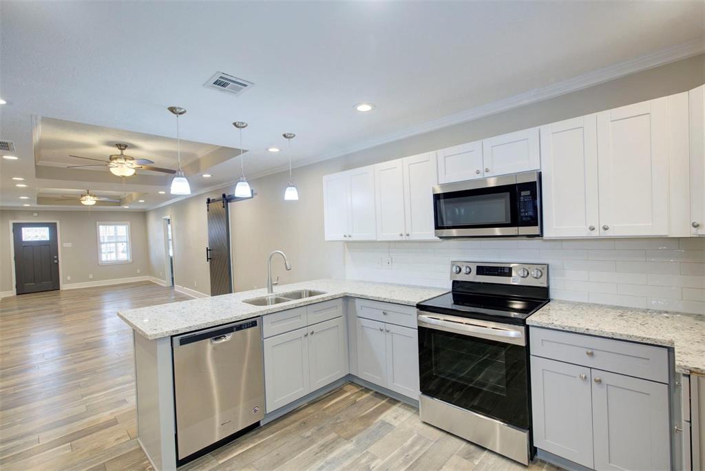 a kitchen with a sink stove and microwave