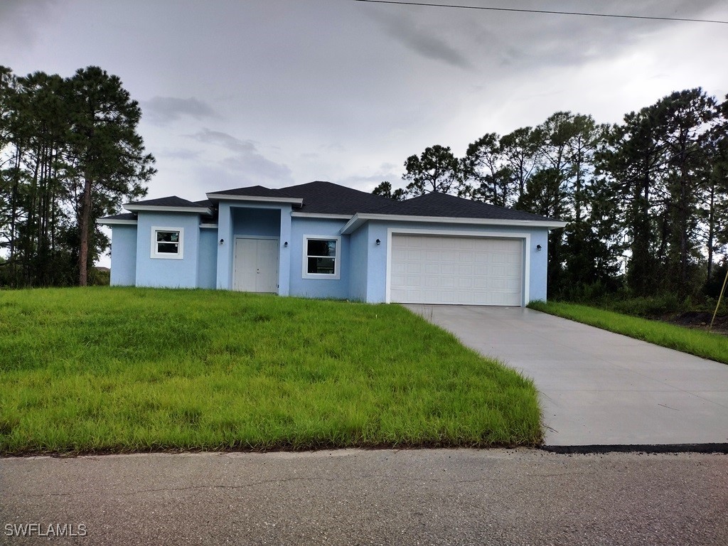 a front view of house with yard and green space