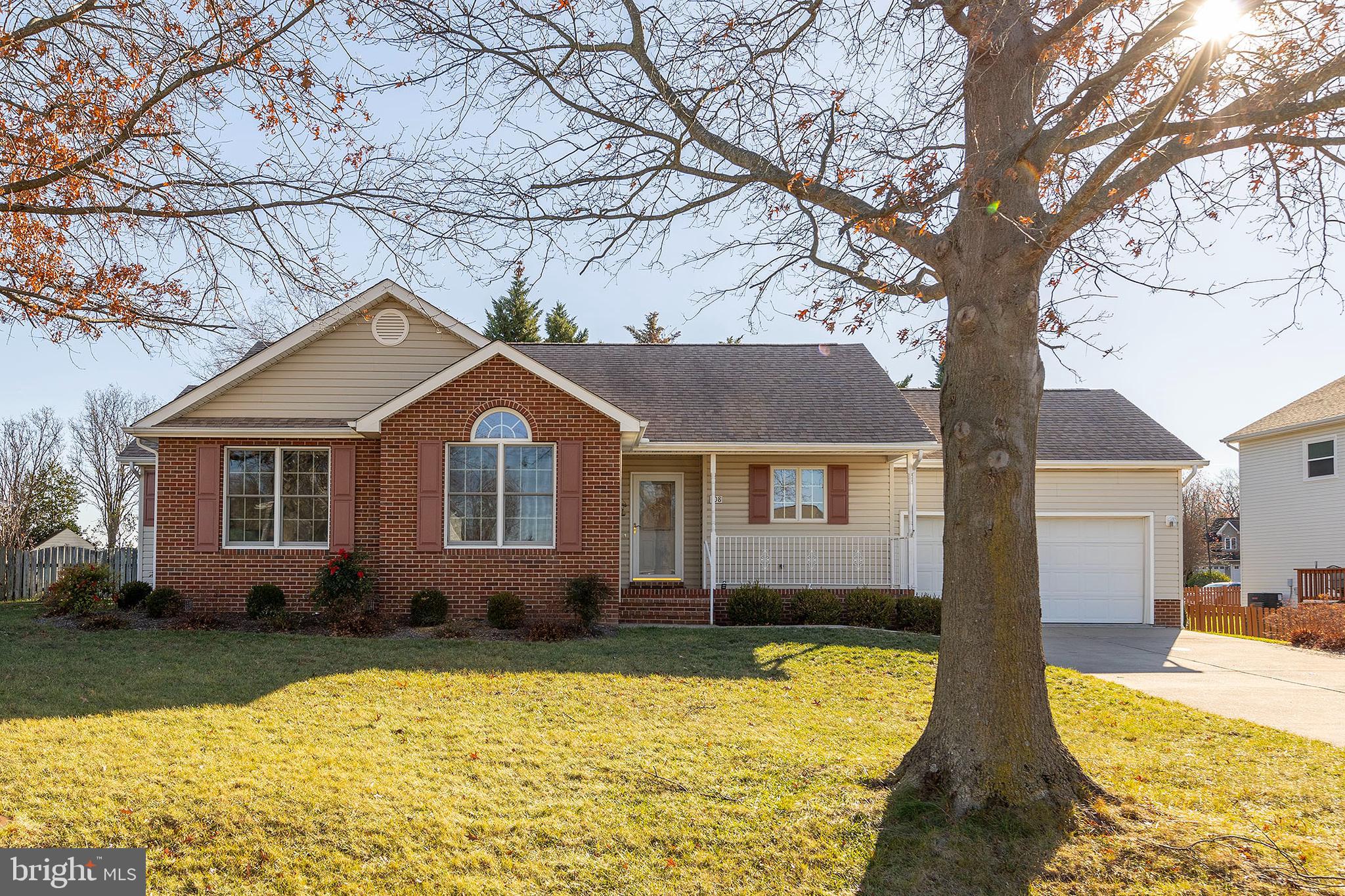 a front view of house with yard and trees around