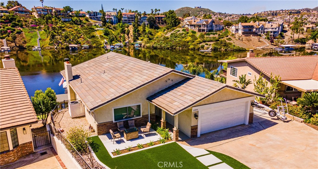 an aerial view of a house with swimming pool and ocean view