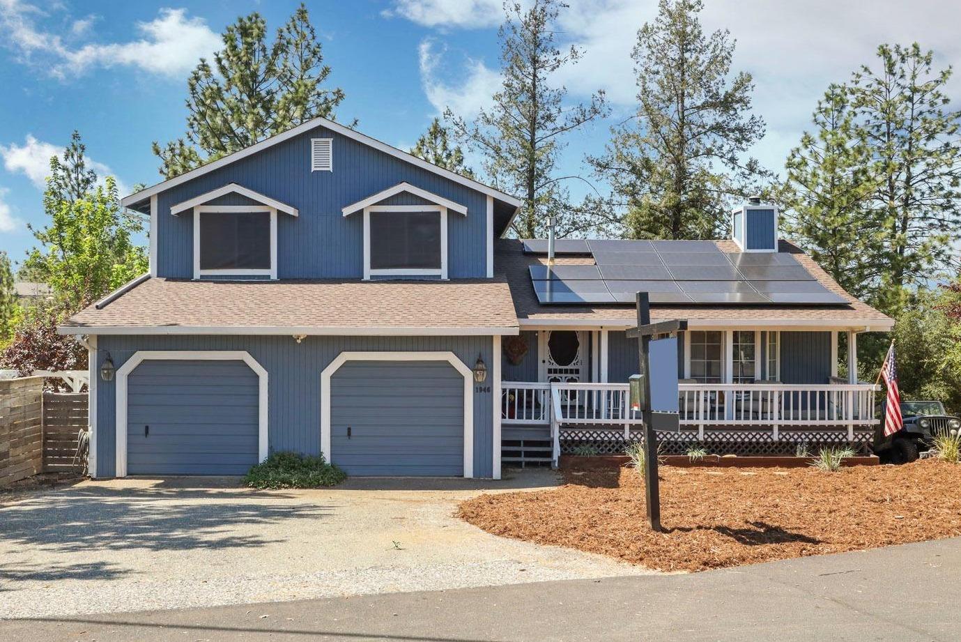 a house that has a tree in front of it