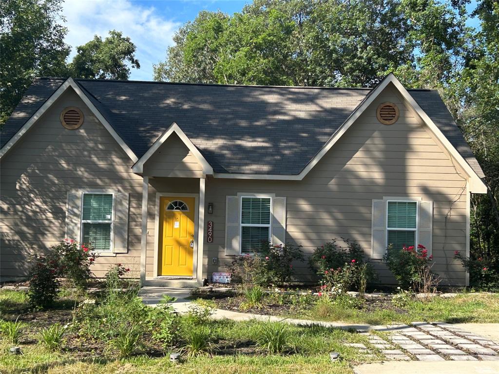 a view of house with yard and green space