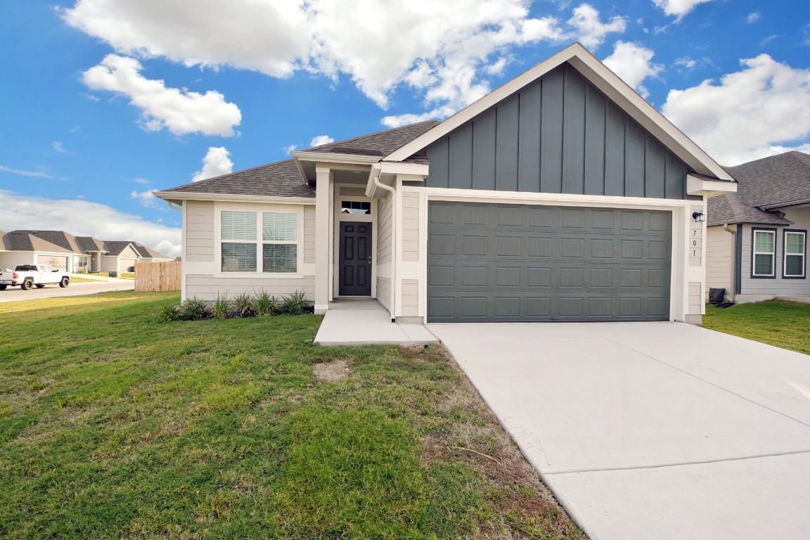 a front view of a house with a yard and garage