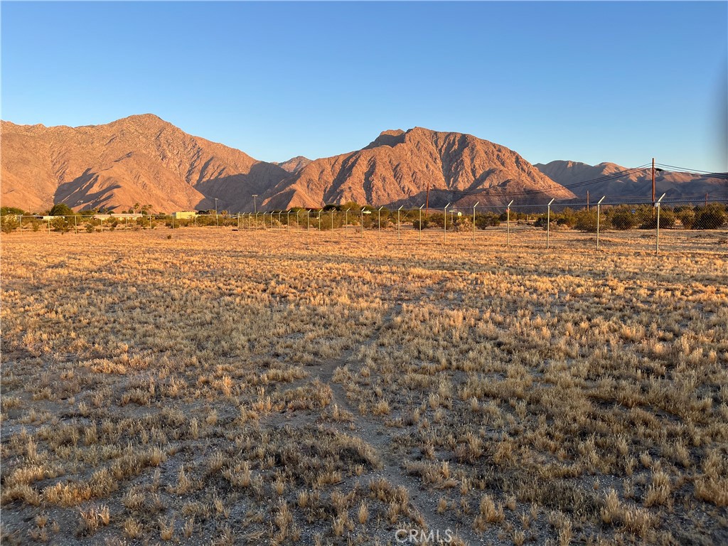 a view of a large mountain with mountains in the background