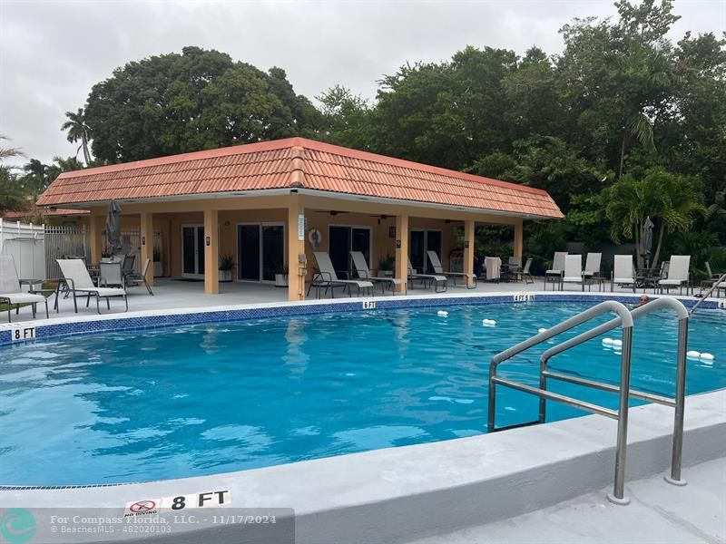 a view of a swimming pool with chairs