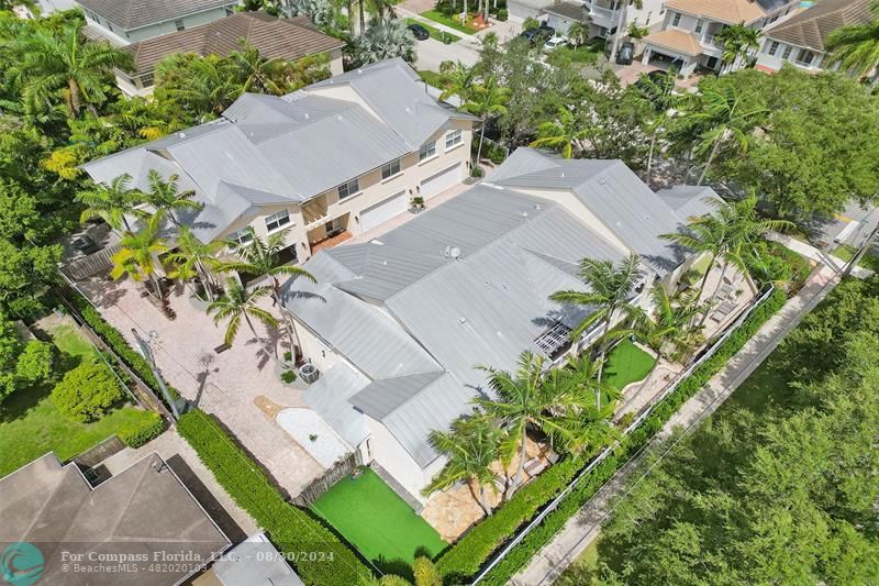 an aerial view of a house with a yard and a garden