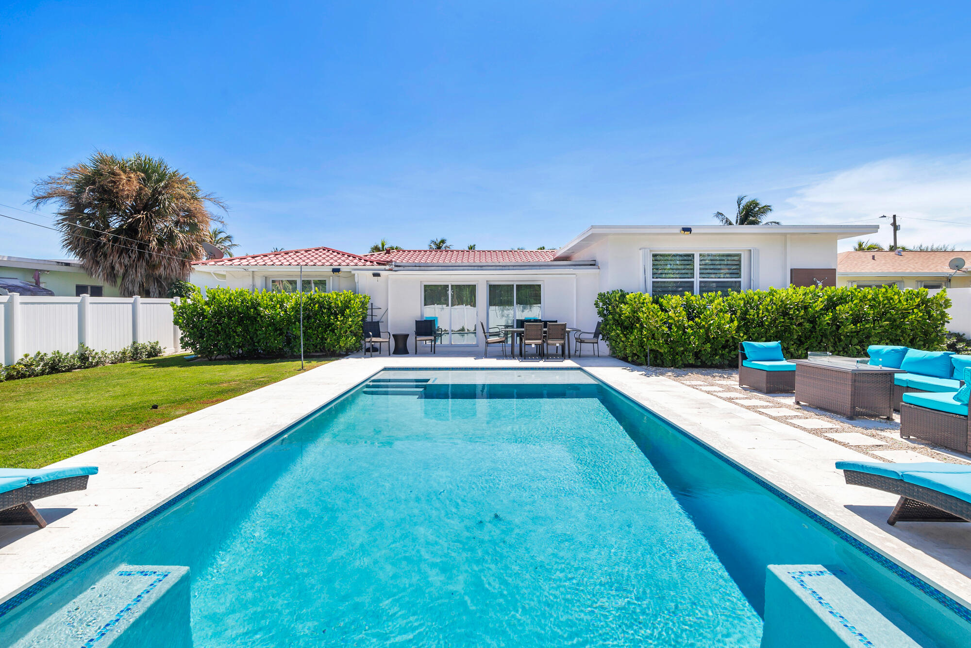 a view of house with swimming pool yard and outdoor seating