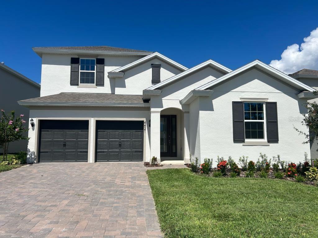 a front view of a house with a yard and garage