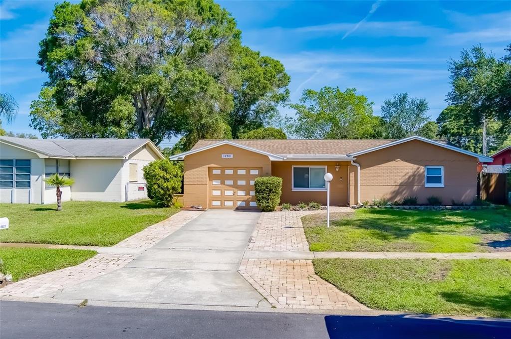 a front view of a house with a yard and garage