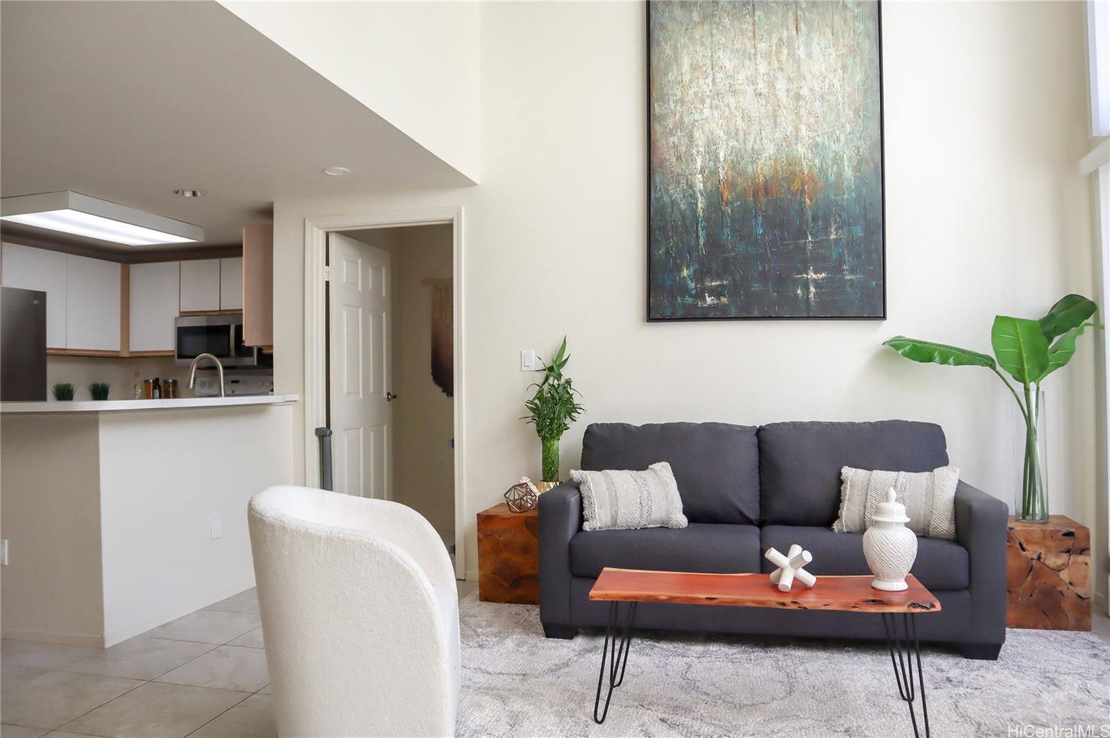 a living room with furniture and a kitchen