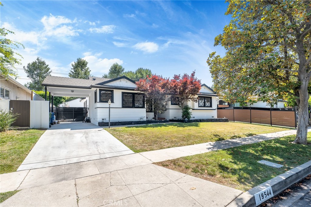 a front view of house with yard outdoor seating and barbeque oven