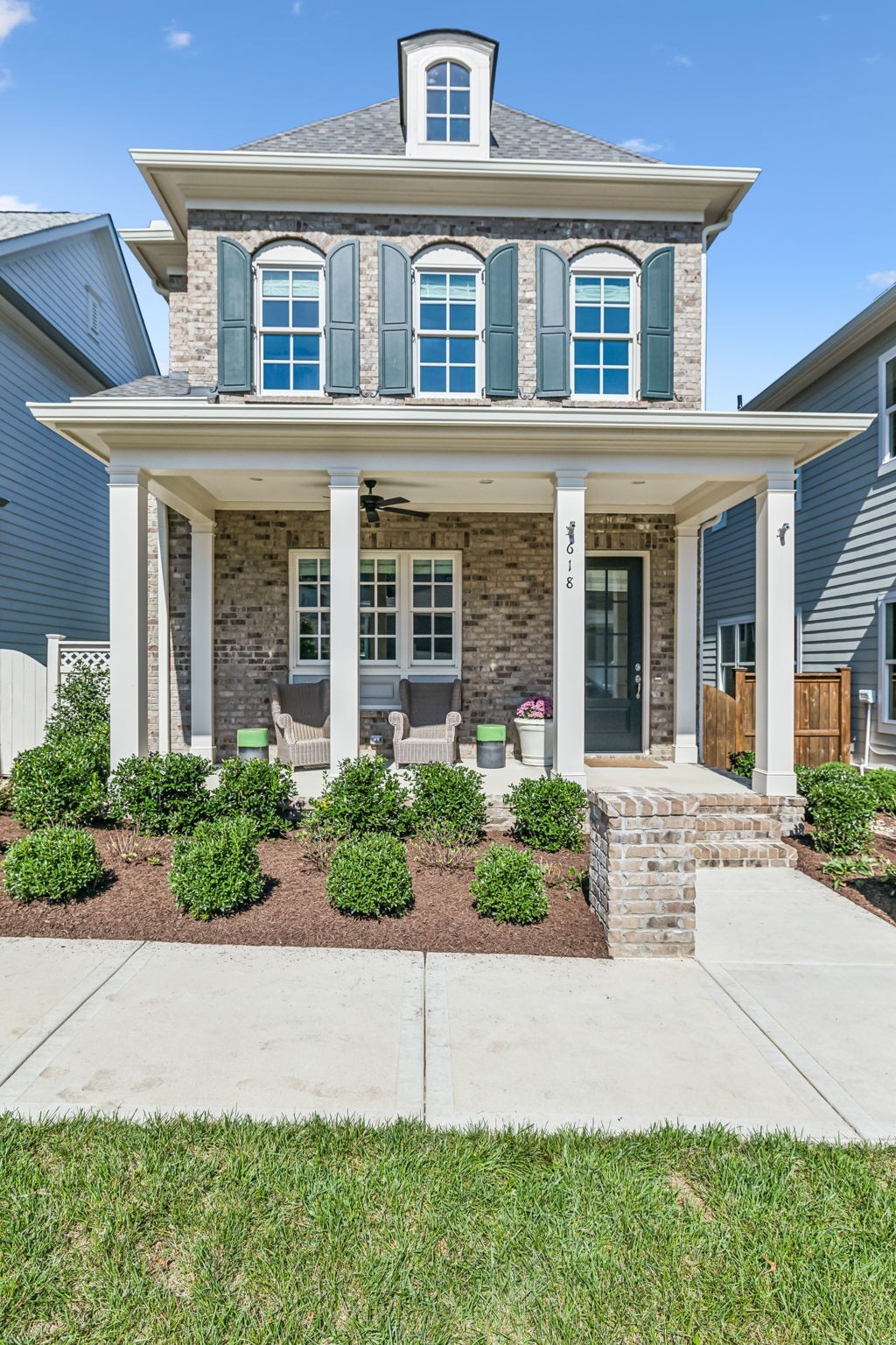 front view of house with potted plants