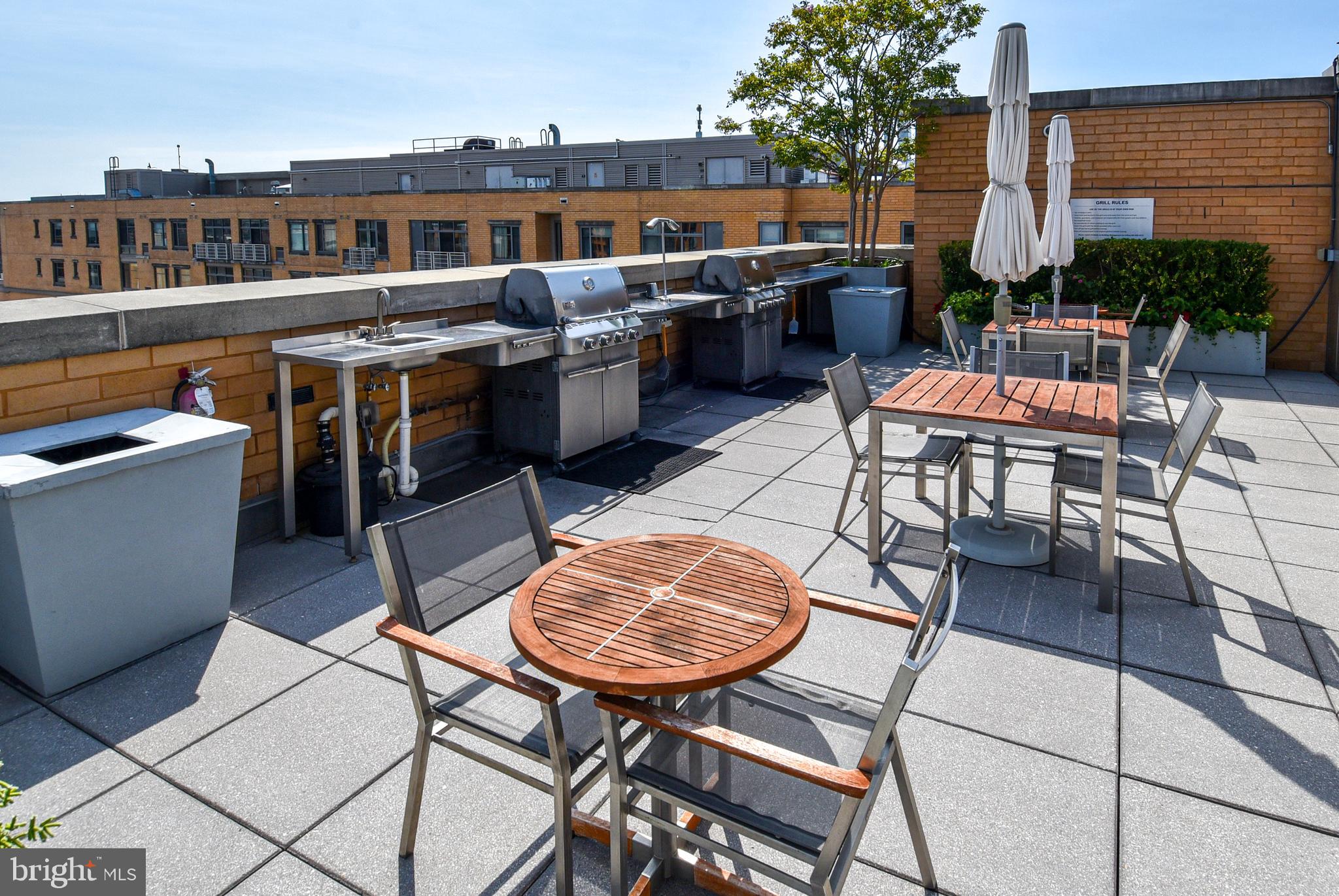 a view of a patio with a dining table and chairs with wooden floor