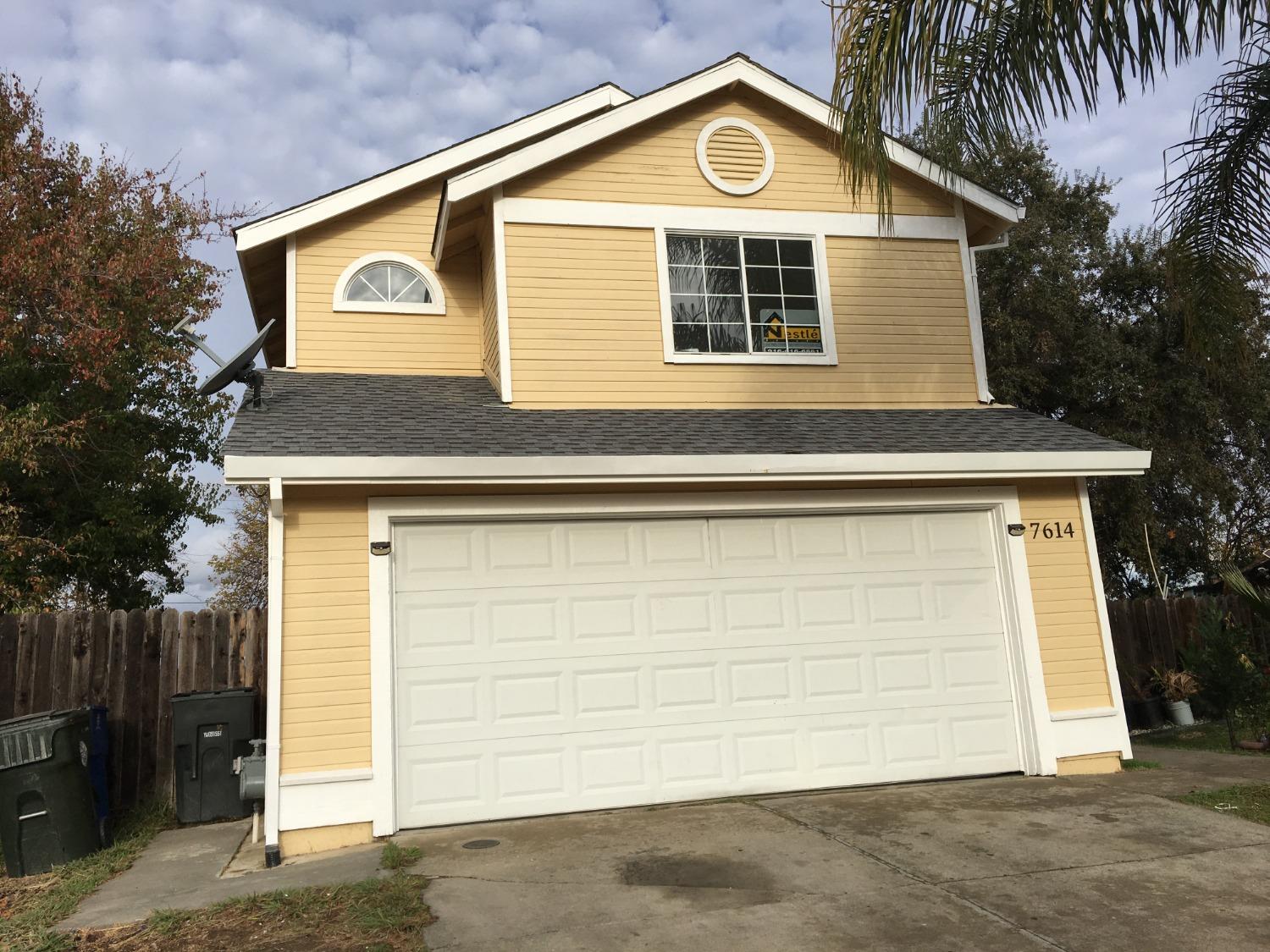 a front view of a house with a garage