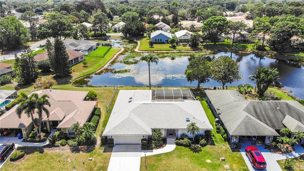 an aerial view of a house with swimming pool and lake view