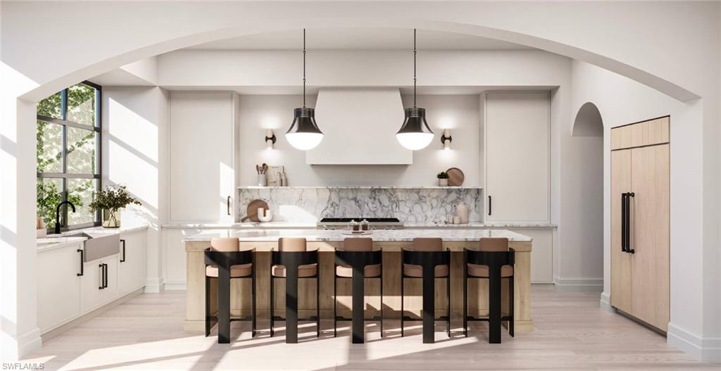 a kitchen with stainless steel appliances a table and chairs in it