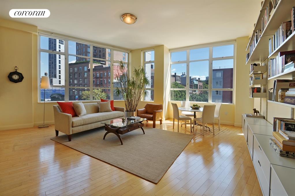 a living room with furniture and a floor to ceiling window