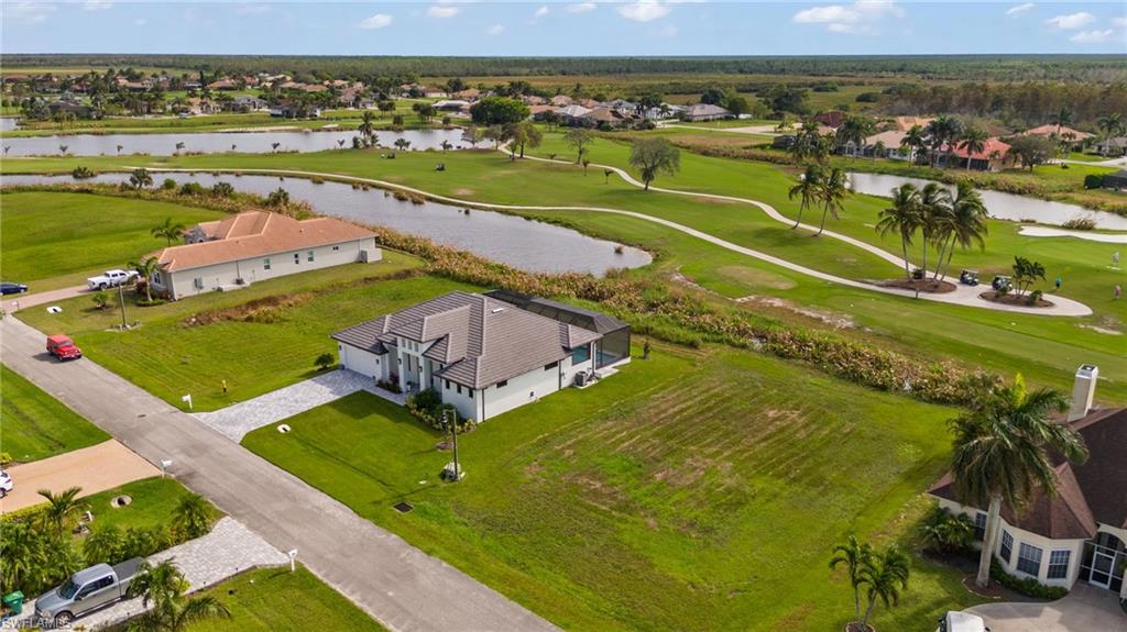 an aerial view of a houses with a yard