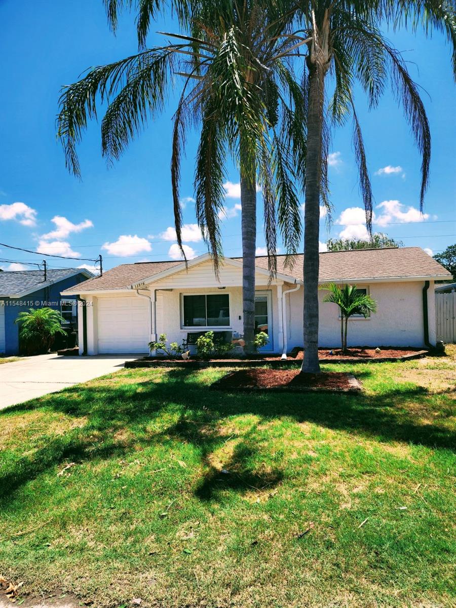 a front view of house with yard and outdoor seating