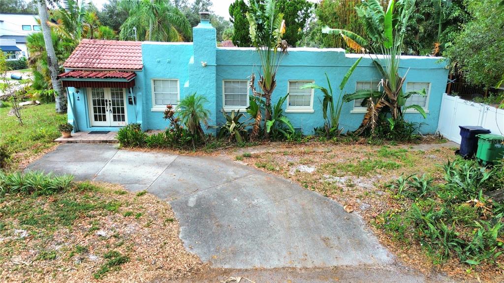 a front view of a house with a garden