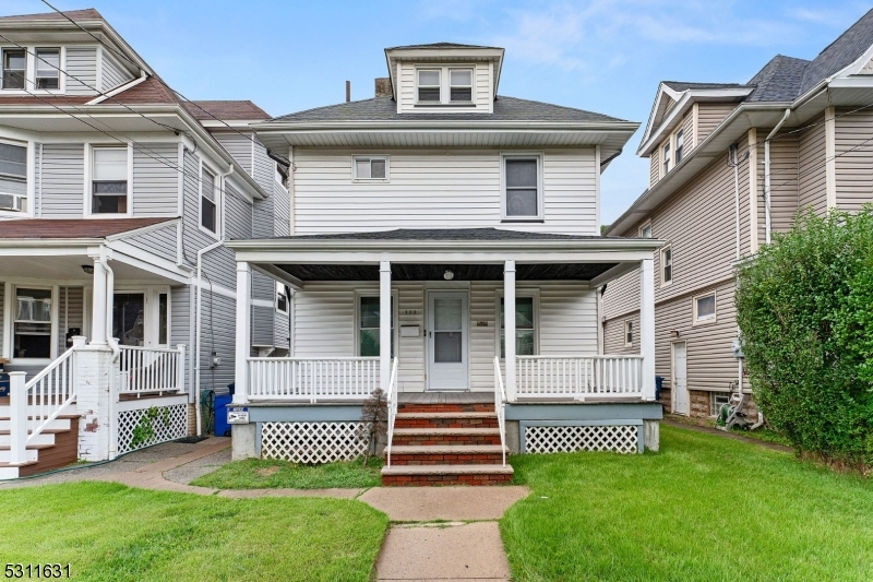 a front view of a house with a garden