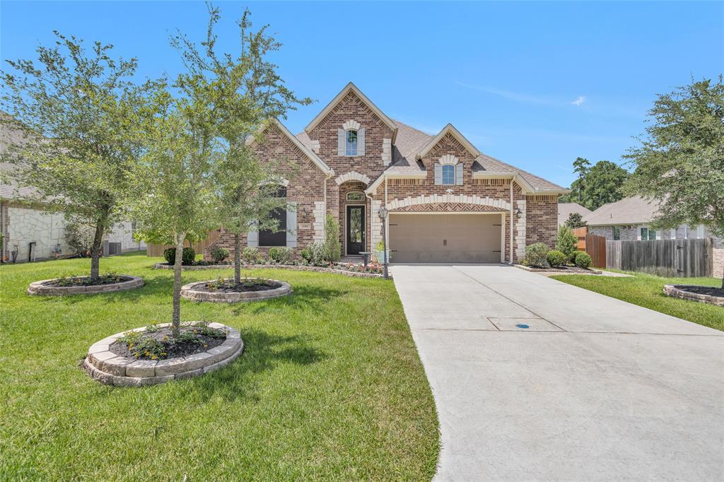 a front view of a house with a yard garage and a fountain