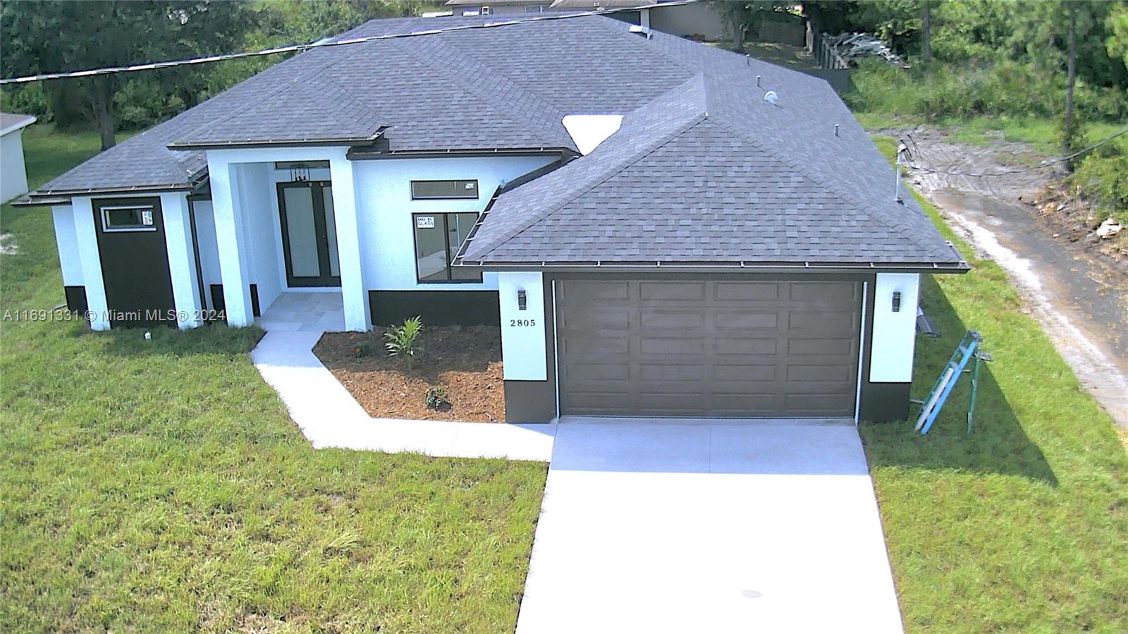 a view of a house with a yard and garage