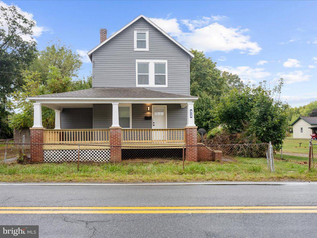 a front view of a house with a garden and yard